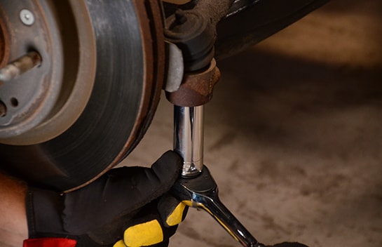 Chris from O’Reilly Auto Parts removing the tie rod end nut with a socket